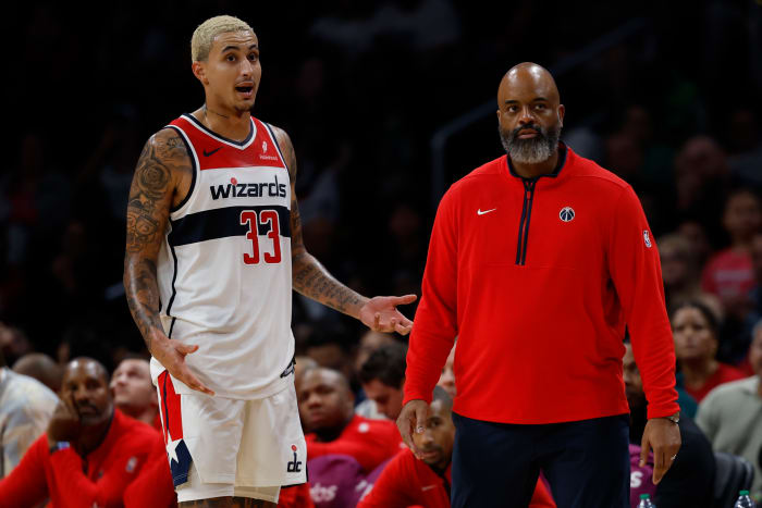 Washington Wizards forward Kyle Kuzma (33) talks with Wizards head coach Wes Unseld Jr. (R) against the Boston Celtics in the third quarter at Capital One Arena.
